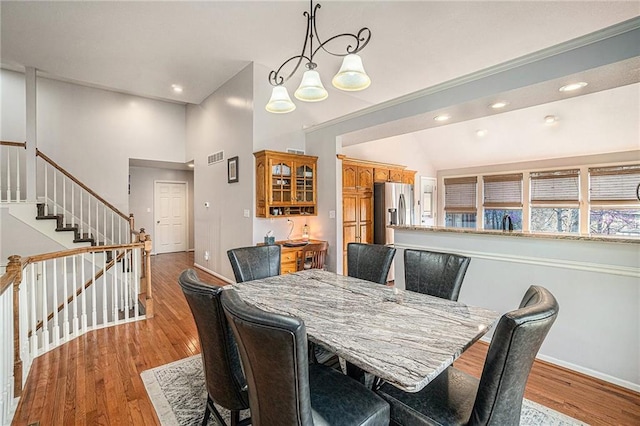 401 NW 51st St, Gladstone, MO 64118 - dining area with stairs, baseboards, wood finished floors, recessed lighting, and vaulted ceiling