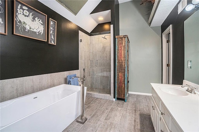 401 NW 51st St, Gladstone, MO 64118 - full bathroom with a freestanding tub, a shower stall, vanity, vaulted ceiling, and baseboards