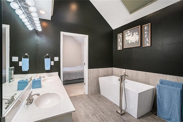 401 NW 51st St, Gladstone, MO 64118 - full bath with a soaking tub, double vanity, wood finished floors, lofted ceiling, and a wainscoted wall