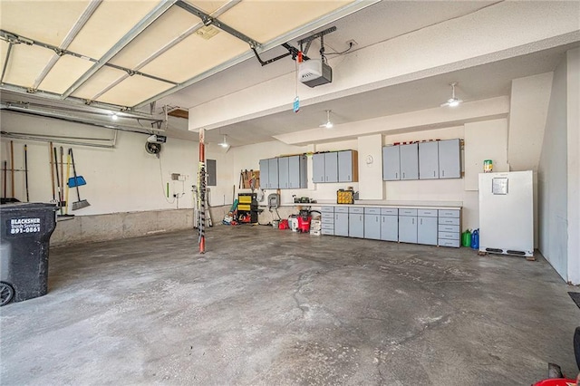 401 NW 51st St, Gladstone, MO 64118 - garage featuring a garage door opener and electric panel
