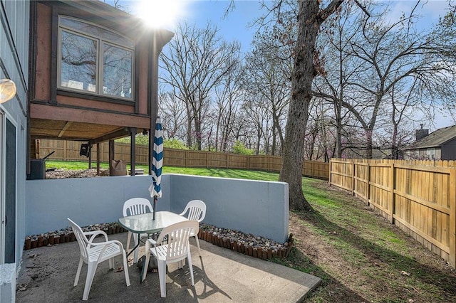 401 NW 51st St, Gladstone, MO 64118 - fenced backyard featuring a patio and outdoor dining area