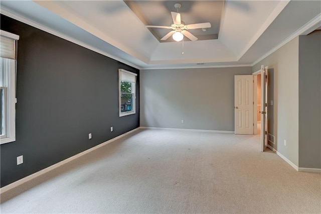carpeted empty room featuring baseboards, a raised ceiling, and ceiling fan