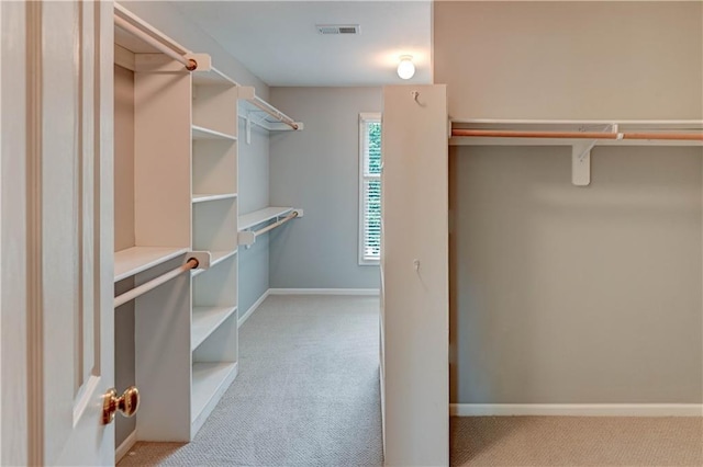 spacious closet with visible vents and light carpet