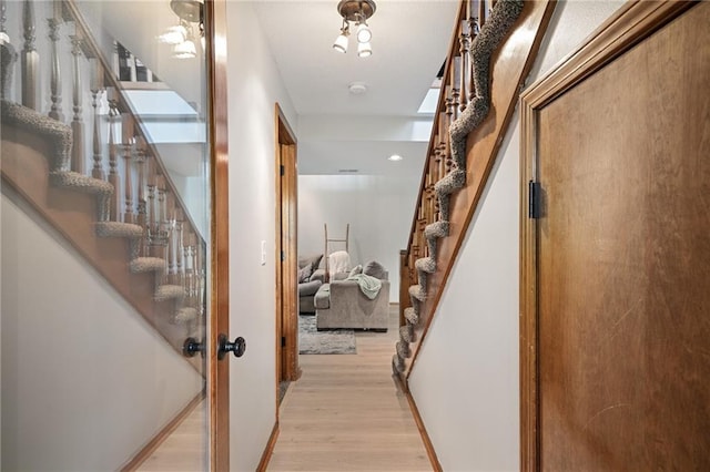2102 W Dennis Ave, Olathe, KS 66061 - hallway with stairs and light wood finished floors