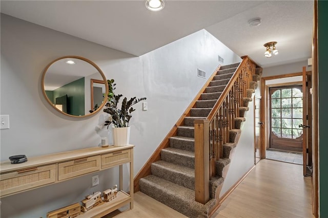 2102 W Dennis Ave, Olathe, KS 66061 - staircase with recessed lighting, visible vents, and wood finished floors