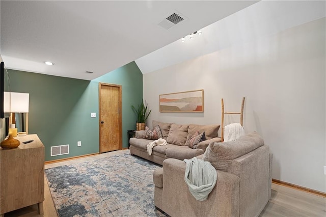 2102 W Dennis Ave, Olathe, KS 66061 - living area with baseboards, light wood finished floors, lofted ceiling, and visible vents