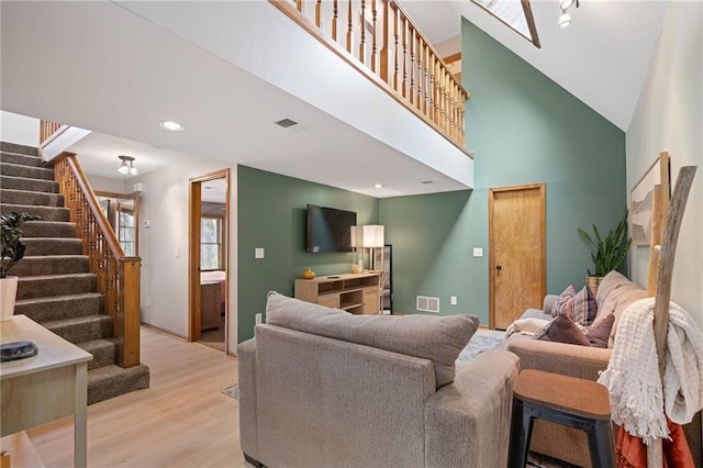 2102 W Dennis Ave, Olathe, KS 66061 - living room featuring a high ceiling, stairs, recessed lighting, wood finished floors, and visible vents