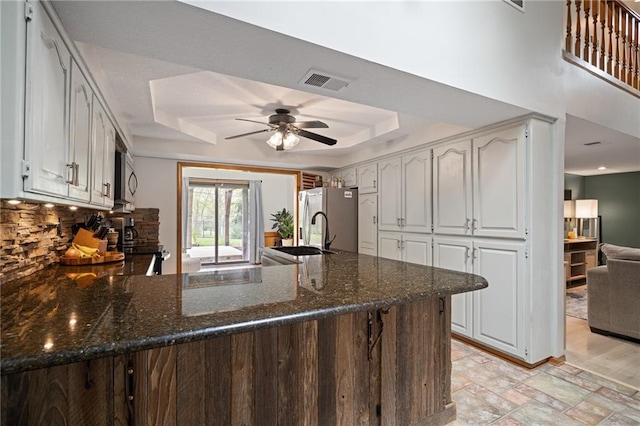 2102 W Dennis Ave, Olathe, KS 66061 - kitchen with ceiling fan, visible vents, a sink, a raised ceiling, and a peninsula