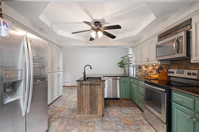 2102 W Dennis Ave, Olathe, KS 66061 - kitchen with a sink, stone finish flooring, appliances with stainless steel finishes, and a tray ceiling