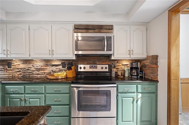 2102 W Dennis Ave, Olathe, KS 66061 - kitchen with green cabinetry, white cabinets, stainless steel appliances, and tasteful backsplash