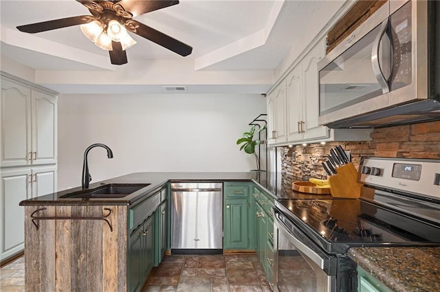 2102 W Dennis Ave, Olathe, KS 66061 - kitchen with a sink, appliances with stainless steel finishes, white cabinets, and green cabinets