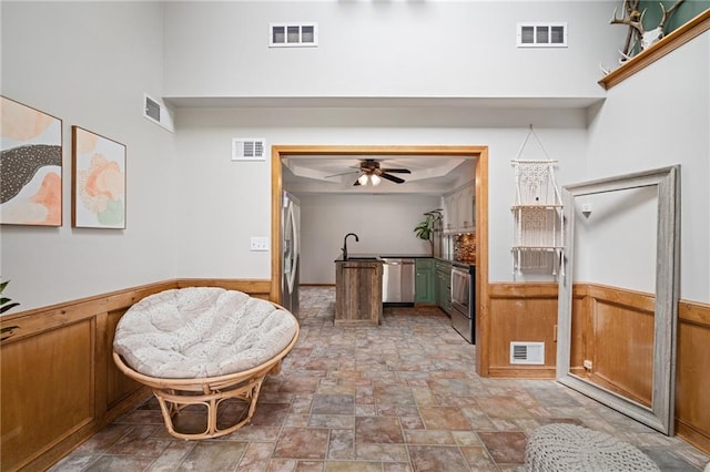 2102 W Dennis Ave, Olathe, KS 66061 - interior space with visible vents, a wainscoted wall, and stone finish floor
