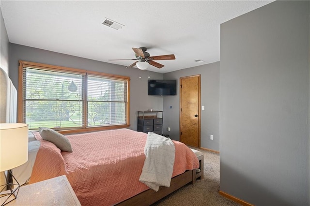 2102 W Dennis Ave, Olathe, KS 66061 - carpeted bedroom with baseboards, ceiling fan, and visible vents