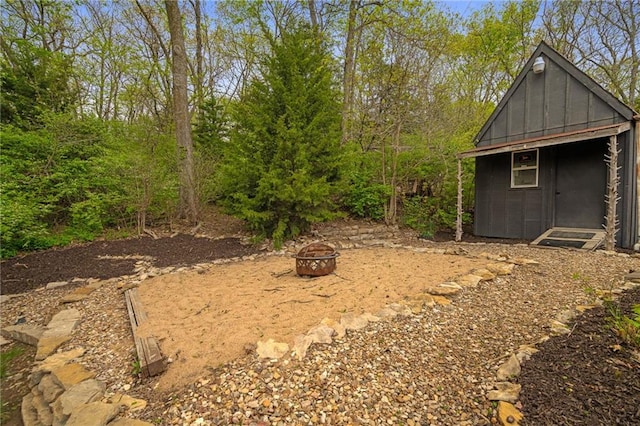 2102 W Dennis Ave, Olathe, KS 66061 - view of yard featuring an outbuilding and a fire pit