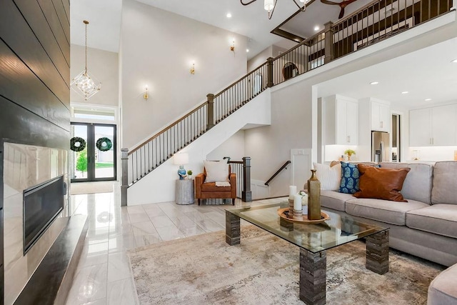 10300 W 174th St, Overland Park, KS 66221 - living area featuring a towering ceiling, light marble finish floors, stairs, a chandelier, and recessed lighting