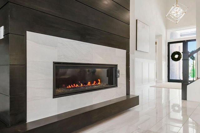 10300 W 174th St, Overland Park, KS 66221 - detailed view of a tiled fireplace and a chandelier