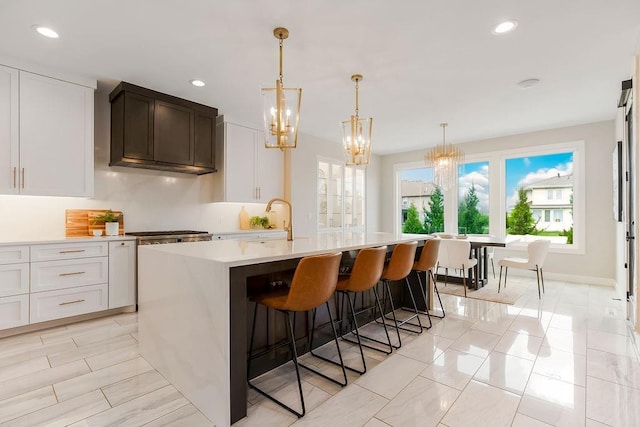 10300 W 174th St, Overland Park, KS 66221 - kitchen with a chandelier, light countertops, a kitchen island with sink, recessed lighting, and decorative light fixtures