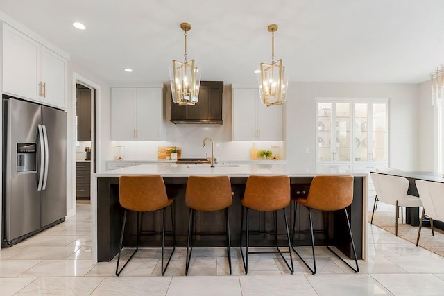 10300 W 174th St, Overland Park, KS 66221 - kitchen with stainless steel fridge, light countertops, a chandelier, a sink, and an island with sink