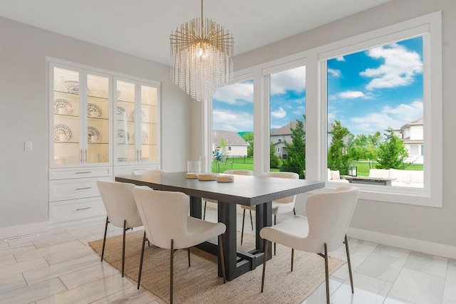 10300 W 174th St, Overland Park, KS 66221 - dining space featuring a chandelier, baseboards, and plenty of natural light