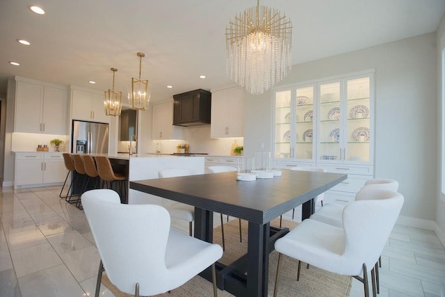 10300 W 174th St, Overland Park, KS 66221 - dining area featuring a chandelier, recessed lighting, baseboards, and light marble finish flooring