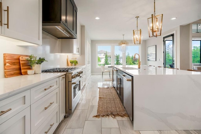 10300 W 174th St, Overland Park, KS 66221 - kitchen with stainless steel appliances, a sink, a chandelier, light stone counters, and recessed lighting