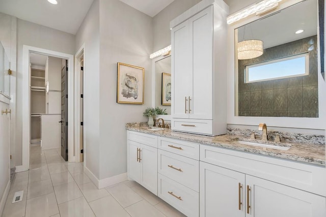 10300 W 174th St, Overland Park, KS 66221 - full bathroom with double vanity, a walk in closet, baseboards, tile patterned flooring, and recessed lighting