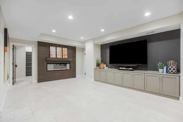 10300 W 174th St, Overland Park, KS 66221 - unfurnished living room featuring a glass covered fireplace, recessed lighting, and baseboards
