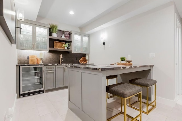 10300 W 174th St, Overland Park, KS 66221 - indoor bar with beverage cooler, decorative backsplash, light tile patterned floors, baseboards, and recessed lighting