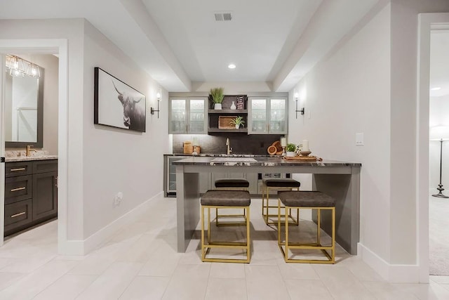 10300 W 174th St, Overland Park, KS 66221 - bar area featuring backsplash, baseboards, a sink, and recessed lighting