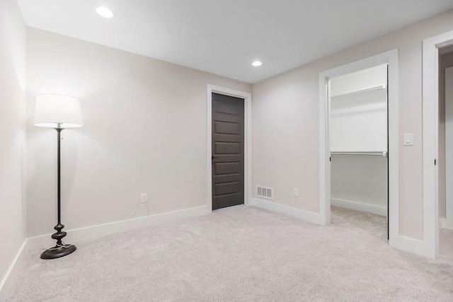 10300 W 174th St, Overland Park, KS 66221 - unfurnished bedroom with baseboards, carpet floors, a walk in closet, recessed lighting, and a closet