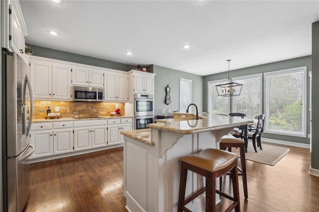kitchen featuring white cabinetry, appliances with stainless steel finishes, and dark wood-type flooring