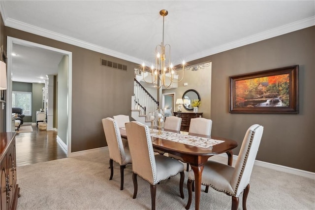 dining room with a notable chandelier, light carpet, stairs, visible vents, and ornamental molding