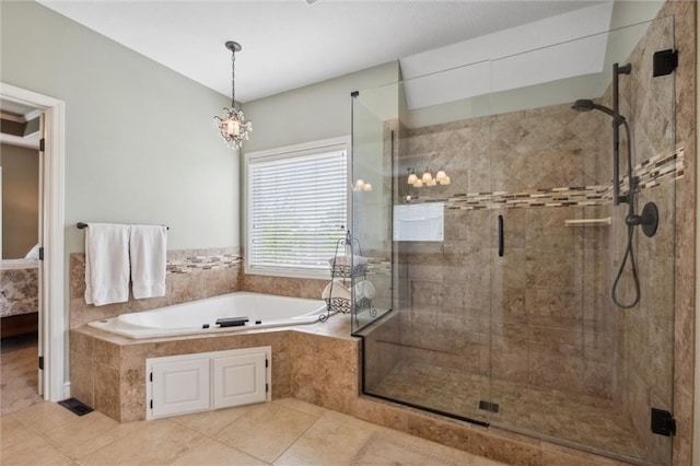 bathroom featuring tile patterned floors, a bath, and a stall shower