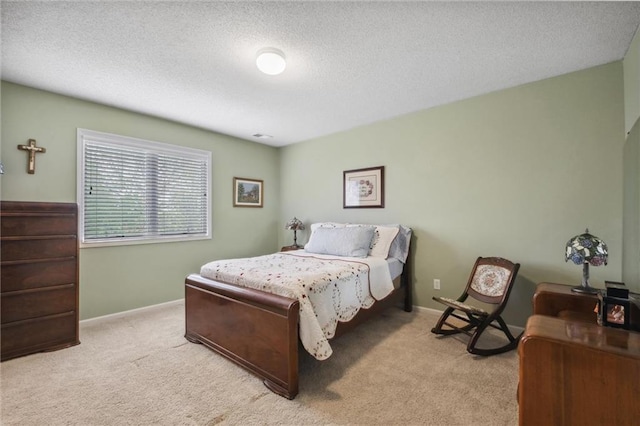 bedroom with carpet floors and a textured ceiling