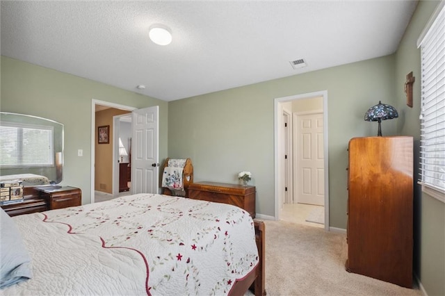 carpeted bedroom featuring baseboards, multiple windows, and visible vents