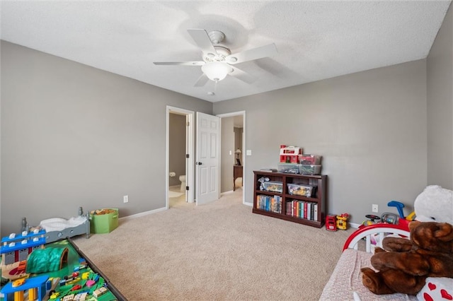 playroom with carpet floors, baseboards, and a ceiling fan