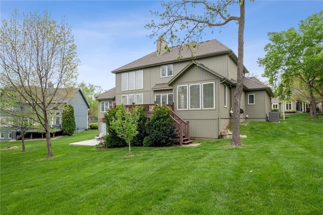 back of house with a yard, a deck, central AC, and stairs