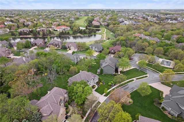 drone / aerial view with a residential view and a water view