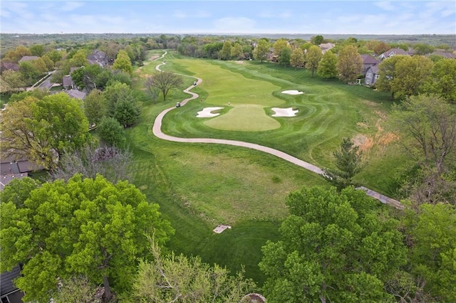 drone / aerial view featuring view of golf course and a residential view