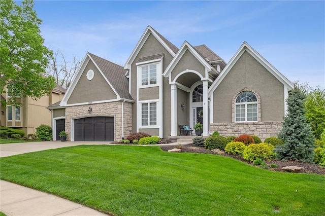 view of front of house featuring stucco siding, a front yard, stone siding, and concrete driveway