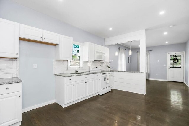 3075 N 31st St, Kansas City, KS 66104 - kitchen featuring light stone countertops, decorative backsplash, white appliances, and a sink