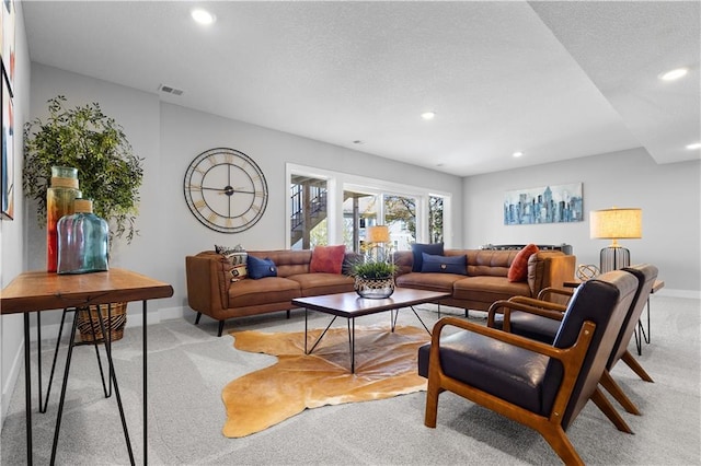 living area featuring baseboards, recessed lighting, a textured ceiling, visible vents, and light colored carpet