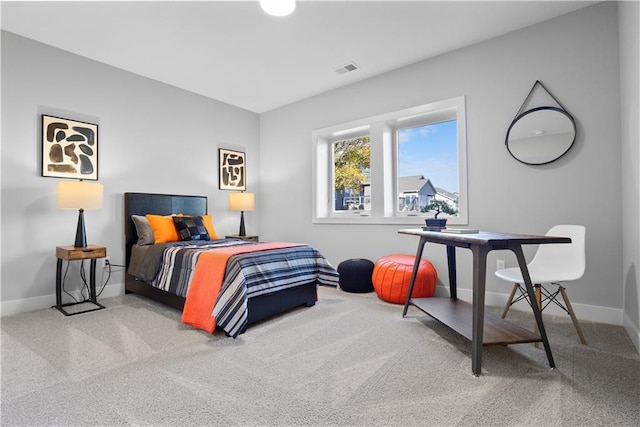 carpeted bedroom featuring visible vents and baseboards