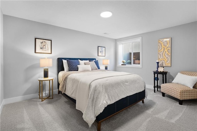 carpeted bedroom featuring baseboards and visible vents