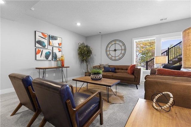 carpeted living room with a textured ceiling, baseboards, visible vents, and recessed lighting