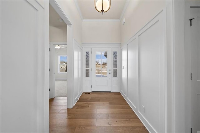 entrance foyer featuring hardwood / wood-style floors and ornamental molding