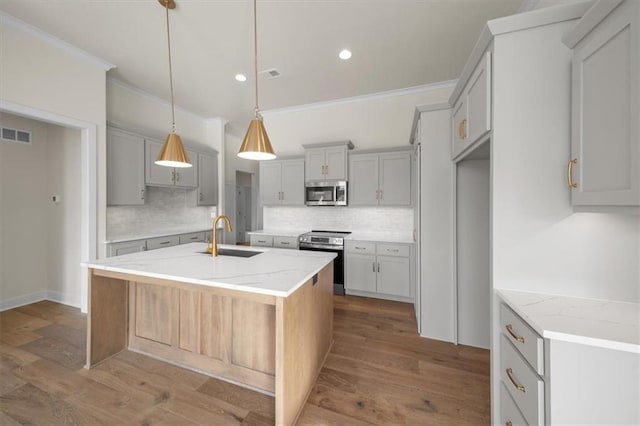 kitchen featuring a sink, ornamental molding, backsplash, and stainless steel appliances
