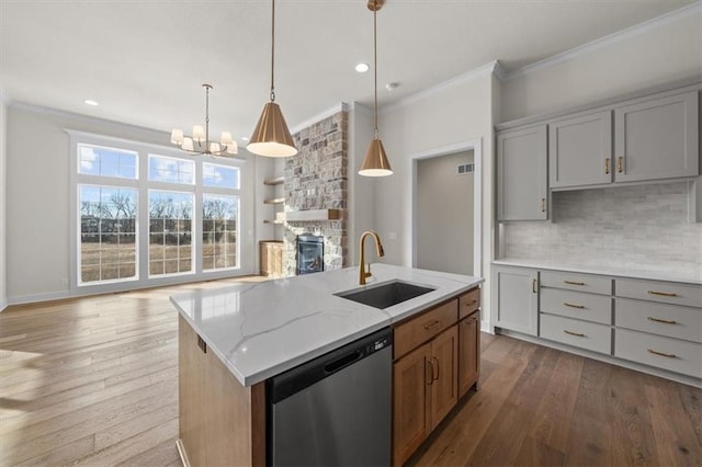 kitchen featuring gray cabinets, crown molding, stainless steel dishwasher, and a sink