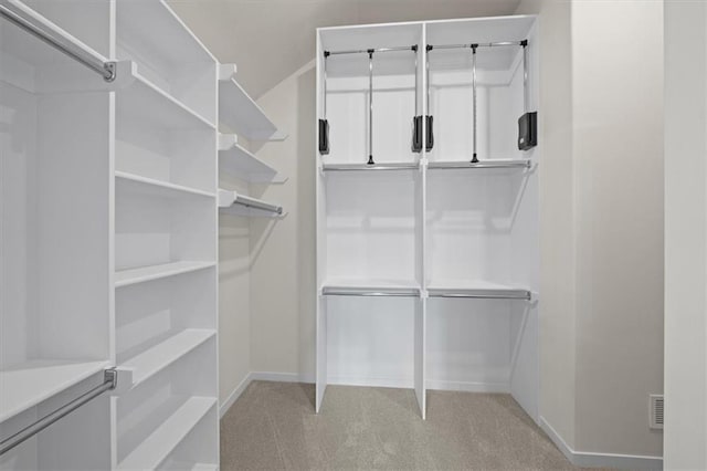 spacious closet with light carpet and visible vents