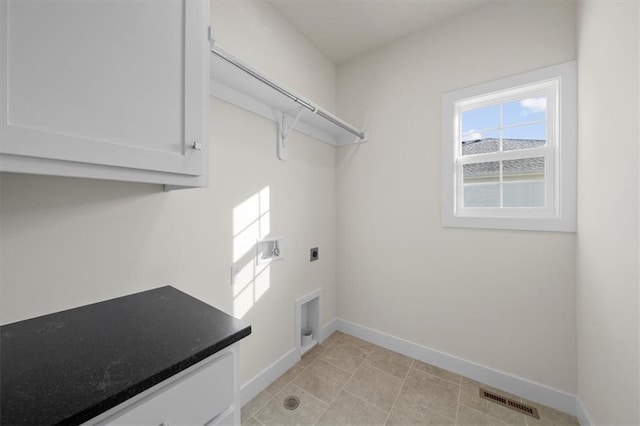 washroom with cabinet space, visible vents, baseboards, and hookup for an electric dryer